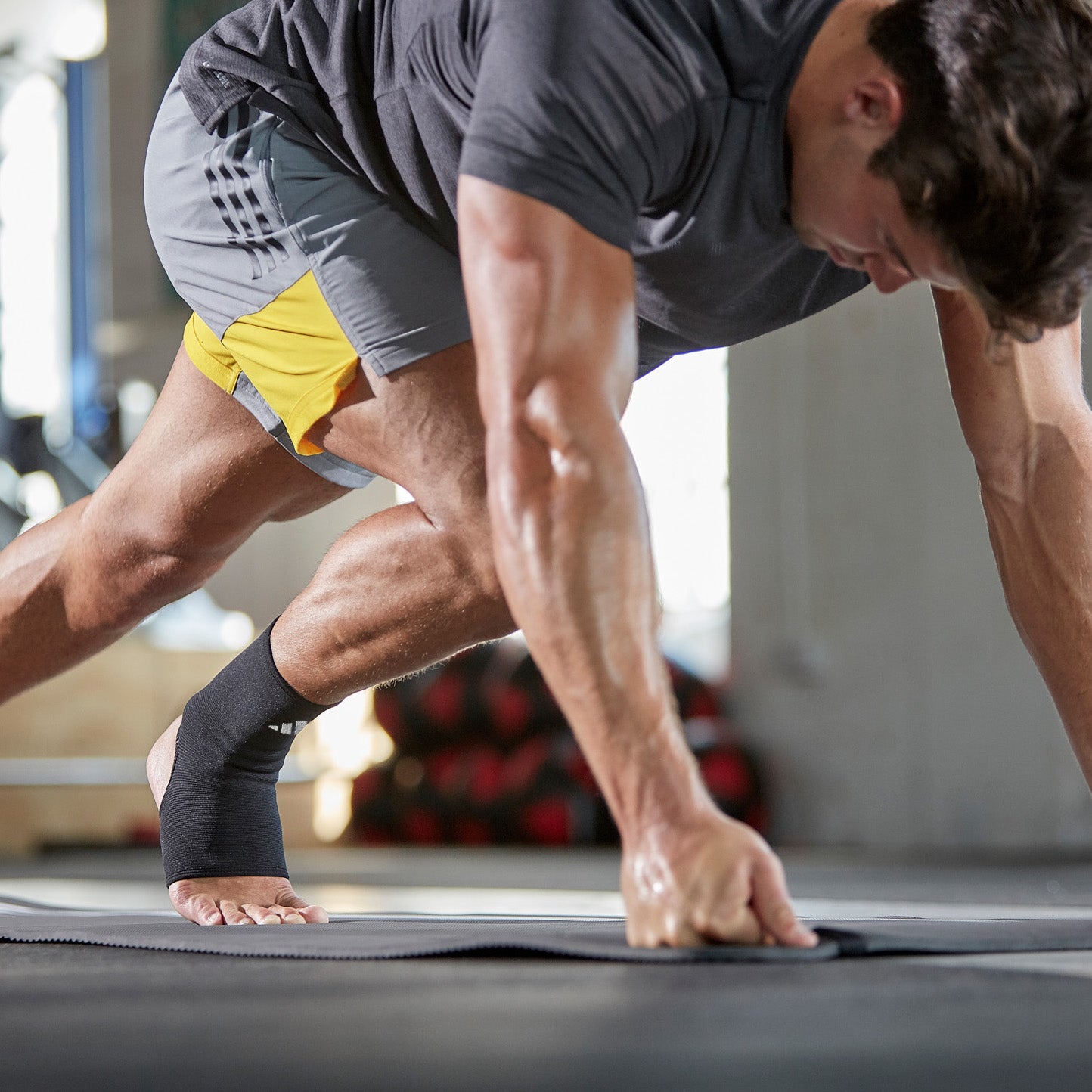 adidas Ankle Support - White on model doing mountain climbers